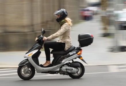 BERLIN, GERMANY - JULY 17: A young woman rides a moped on July 17, 2012 in Berlin, Germany. Mopeds are a common mode of commuter transportation across Europe. (Photo by Sean Gallup/Getty Images)